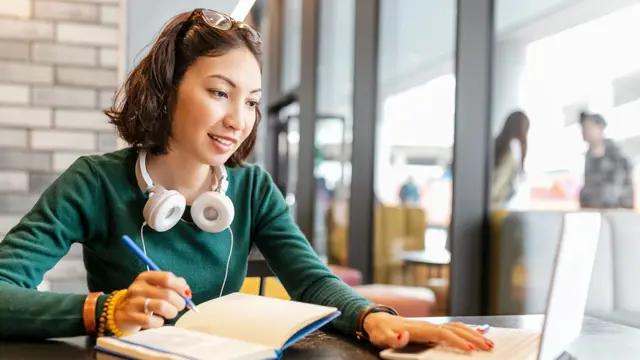 Young Happy Business Asian Woman Taking Notes In Notebook And Working With Laptop Pc Or Computer. Education And Working Concept. Modern Freelance Professions 1024X683
